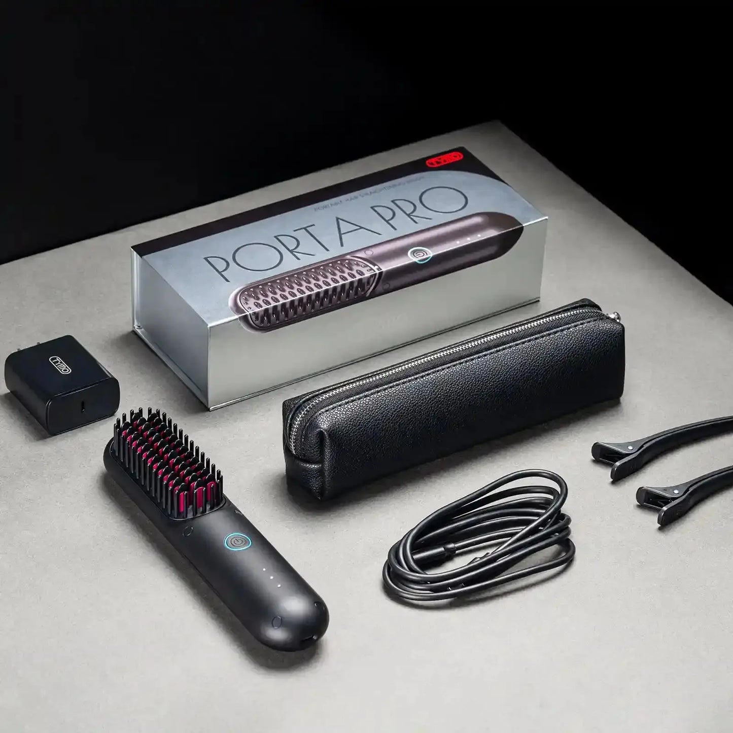 TYMO PORTA PRO hair styler packaging, including hair straightener, carrying case, charging adapter, and accessories.